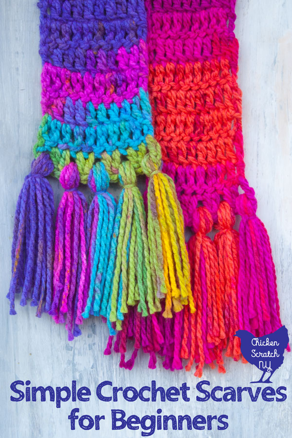 two colorful scarves against a white washed wooden background