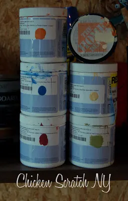 six sample jars of paint for a plywood barn Quilt