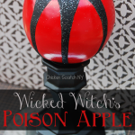 fake apple spray painted and covered in glitter to make a DIY Halloween Witch's Poison Apple