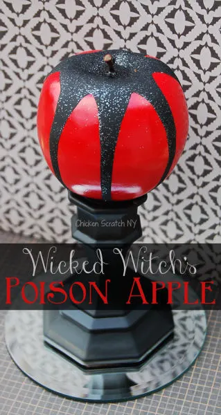 fake apple spray painted and covered in glitter to make a DIY Halloween Witch's Poison Apple