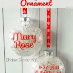 clear ornament filled with fake snow with red vinyl lettering for a childs name, birth date, birth weight, birth time and birth length