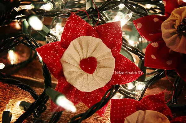 Turn scraps into pretty fabric ornaments combining prairie points, yo-yos and fancy buttons