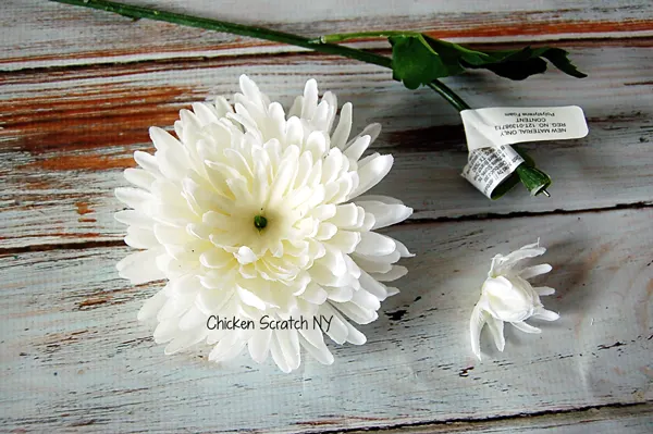 Decorate a festive holiday yarn wreath with reassembled jingle bell flowers