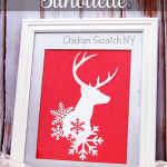 Use an vinyl stencil and looking glass spray paint to craft a winter deer mirror perfect to reflect the twinkling holiday lights
