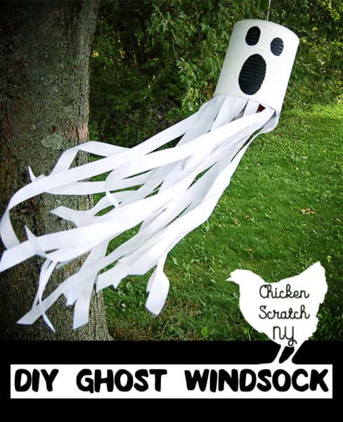 Turn an empty can into a glowing phantom with this DIY tutorial for a ghost windsock with ribbon and paint for a spooky friend straight from the recycle bin