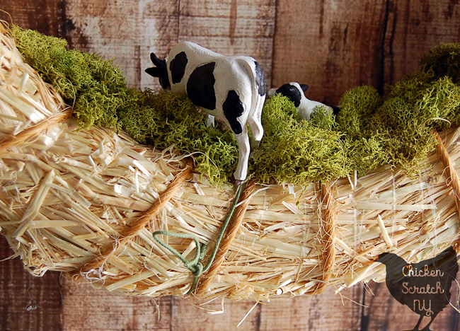 Add some rural charm to your front door with a DIY Spring Farm Wreath featuring a straw wreath, bailing twine and cows with this quick & easy tutorial
