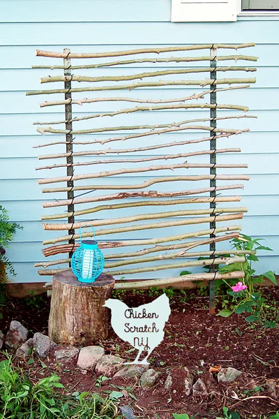 Give your climbing plants a hand with this budget friendly t-post trellis. T-posts, zip ties and branches come together to make a charming garden accent