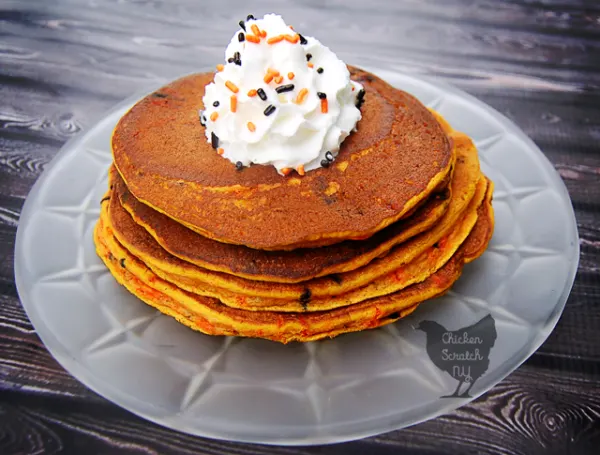 Pumpkin, Spice & everything nice come together for a Halloween breakfast treat of pumpkin pancakes jazzed up with black & orange sprinkle confetti