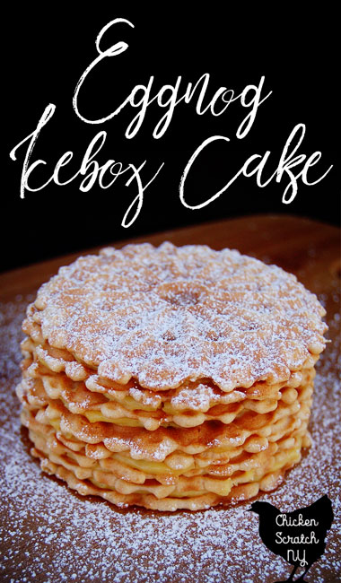 vanilla pizzelle cookies with eggnogg pudding pilling stackes and dusted with powdered sugar on a wooden surface