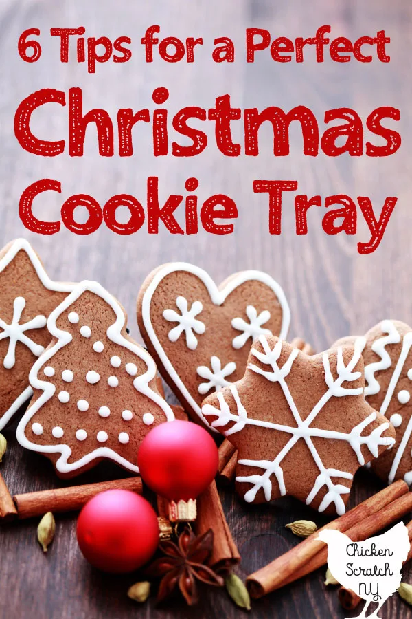 hazy wooden surface holding red Christmas bulbs and fancy gingerbread cookies decorated with white royal icing red text overlay 6 tips for a perfect Christmas cookie tray