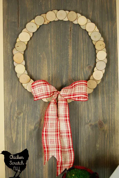 Decorate with a DIY rustic snowman and wood slice wreath for a simple display to carry you from Christmas though the winter season