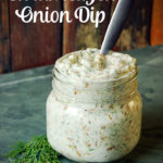 caramelized onion sip in a glass jar with fresh dill on green tile
