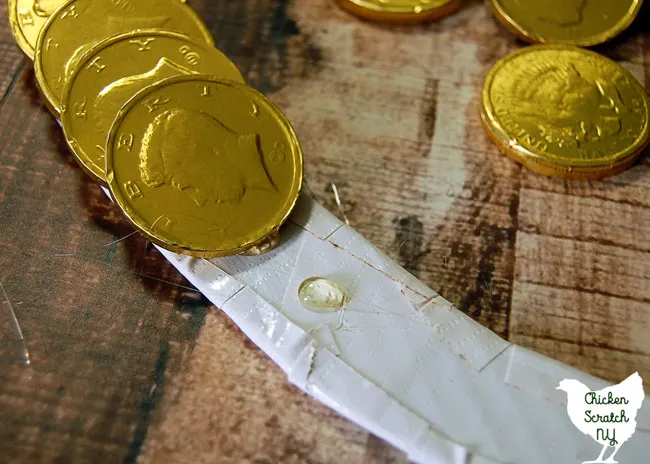 hot glue chocolate coins to cardboard wreath form