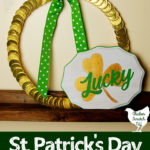 chocolate coin st. patrick's ay wreath on wooden shelf with white, gold and green sign that says lucky