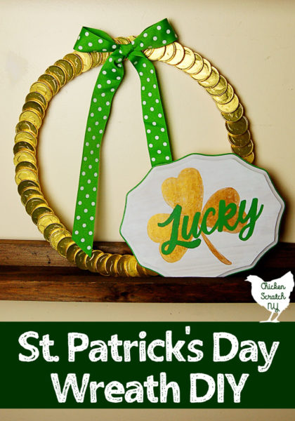 chocolate coin st. patrick's ay wreath on wooden shelf with white, gold and green sign that says lucky