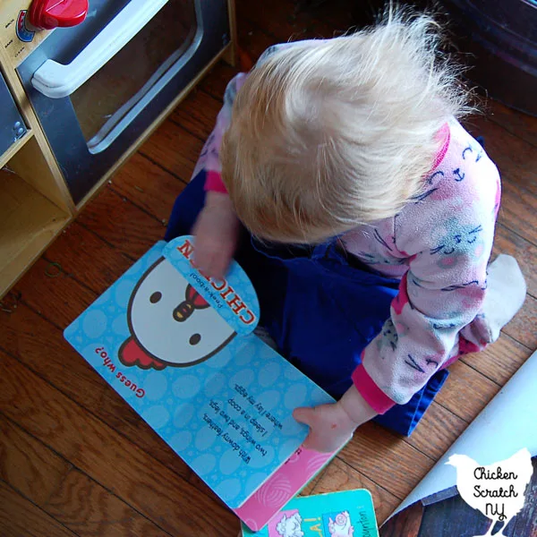 little girl reading peek-a-boo farm