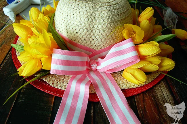 sun hat turned into a apring wreath with yellow tulips and pink striped ribbon