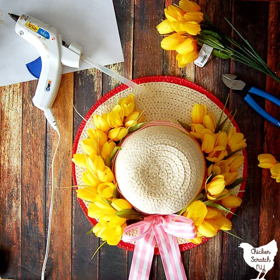 sun hat turned into a apring wreath with yellow tulips and pink striped ribbon