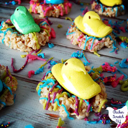 Marshmallow peep chick in rice crispie nest decorated with candy melts and sprinkles