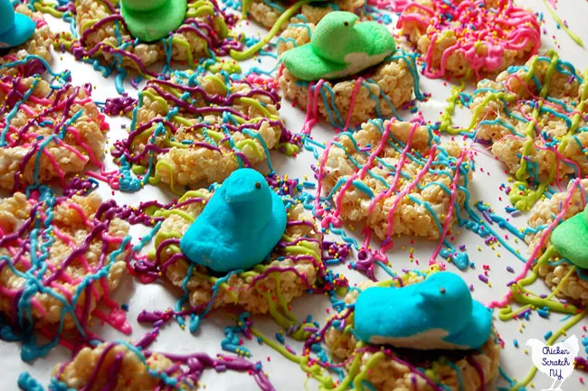 Marshmallow peep chick in rice crispie nest decorated with candy melts and sprinkles