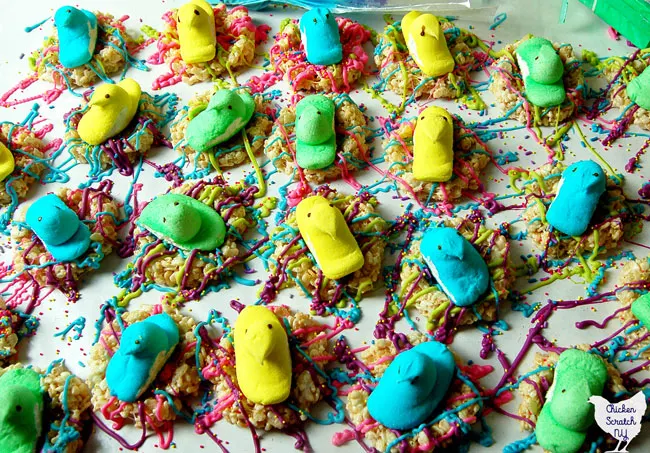 Marshmallow peep chick in rice crispie nest decorated with candy melts and sprinkles