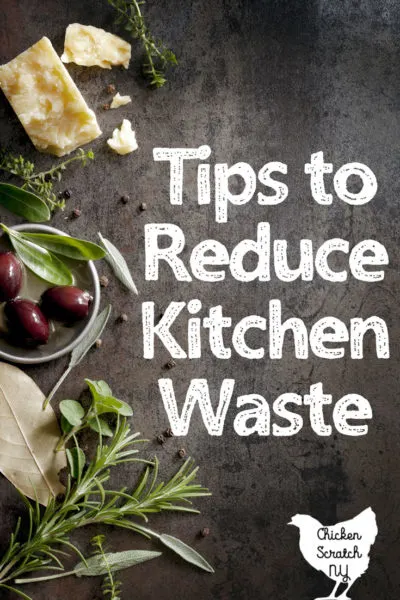 wooden board with olives, chees and herbs with text overlay Tips to Reduce kitchen waste