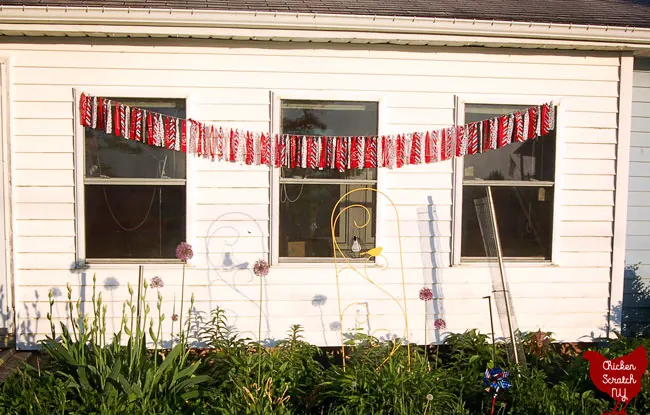 4th of July no sew americana garland from bandanas hanging in a flower garden