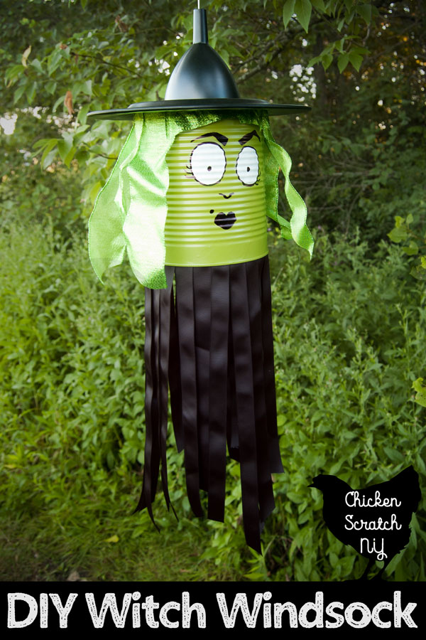 witch windsock made from a green painted tin can, black ribbon, green ribbons, a plate and funnel