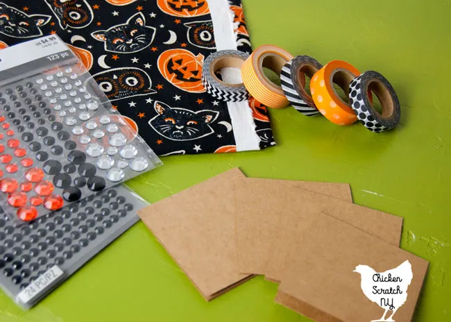 halloween banner supplies: halloween fabric, washi tape, not cards and self adhesive rhinestones