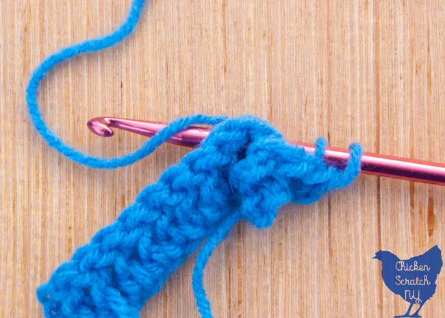 crocheting around the post to the back in blue super saver yarn