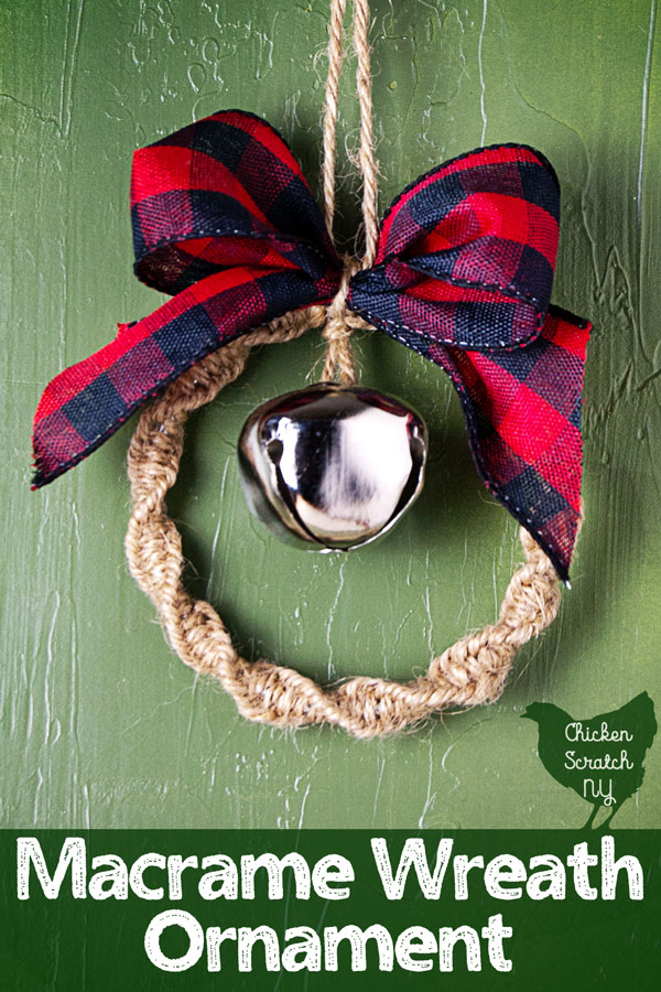 Macramé wreath ornament made with twine, silver bell and and buffalo check ribbon