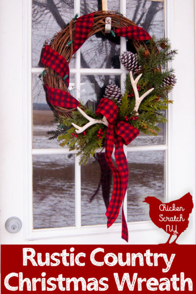 rustic farmhouse country wreath made with buffalo check ribbon, pine cones, antlers and faux greenery