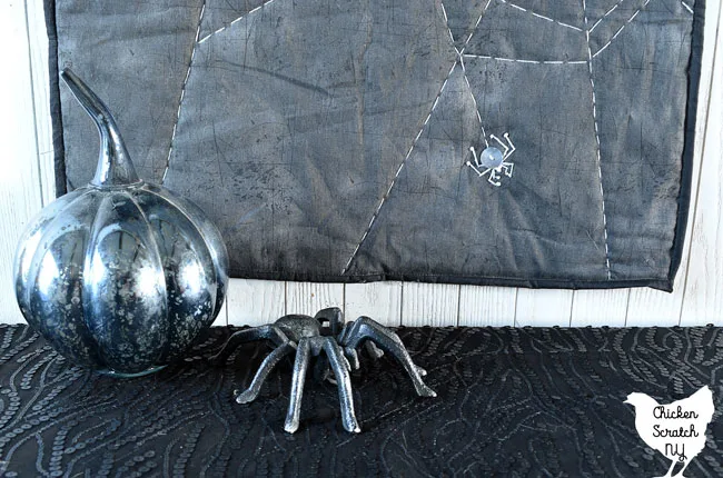 spiderweb table runner with mercury glass pumpkin and cast iron spider