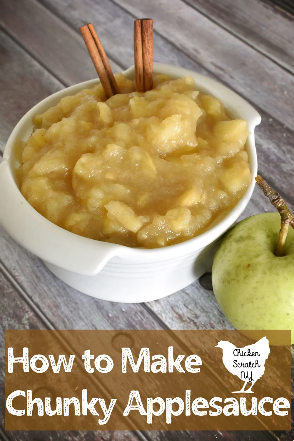 white ceramic bowl willed with warm chunky applesauce made with maple syrup and fall spices with a green apple with cinnamon sticks with text overlay How to Make Chunky Applesauce