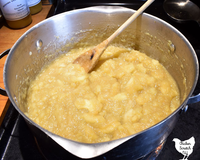 homemade chunky applesauce in a metal pot sweetened with maple syrup