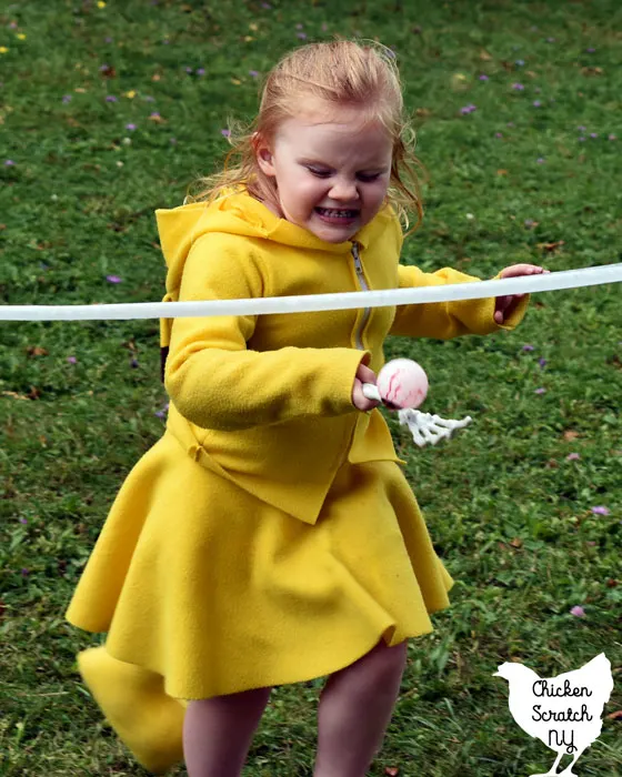 little girl in Pikachu costume playing eyeball on a spoon race Halloween Party Game