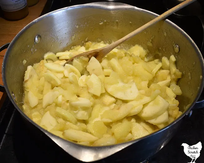 cooking down apple slices to make homemade applesauce 