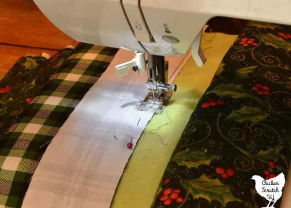 sewing along the side of a jelly roll strip using the side of the presser foot as a guide