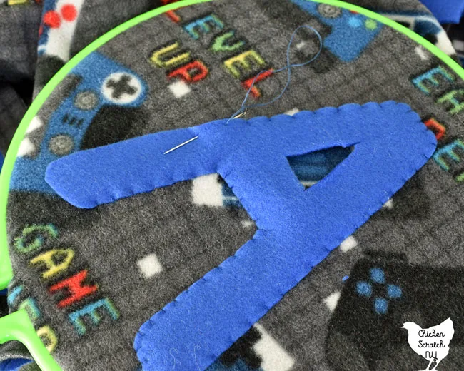 sewing a fleece monogram letter to a fleece blanket