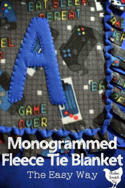 video game patterned fleece and solid blue fleece tie blanket monogrammed with a large fleece A with text overlay "monogrammed fleece tie blanket the easy way"