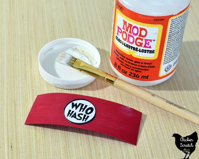 use mod podge to apply printed and cut out "who hash" label to red paper