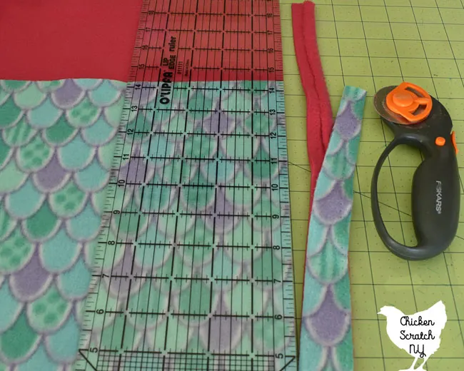 use a rotary mat, rotary blade and ruler to remove the selvage from the fabric