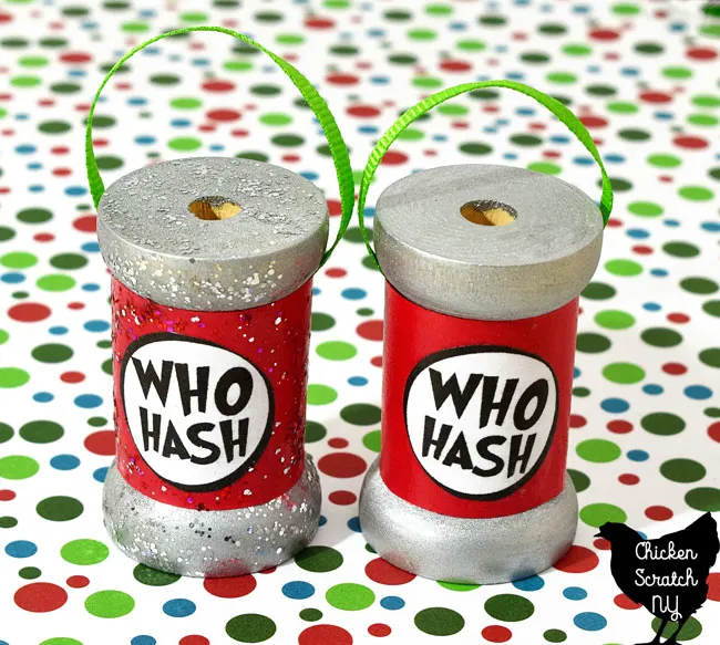two DIY who hash spool ornaments one with glittery paint and one without