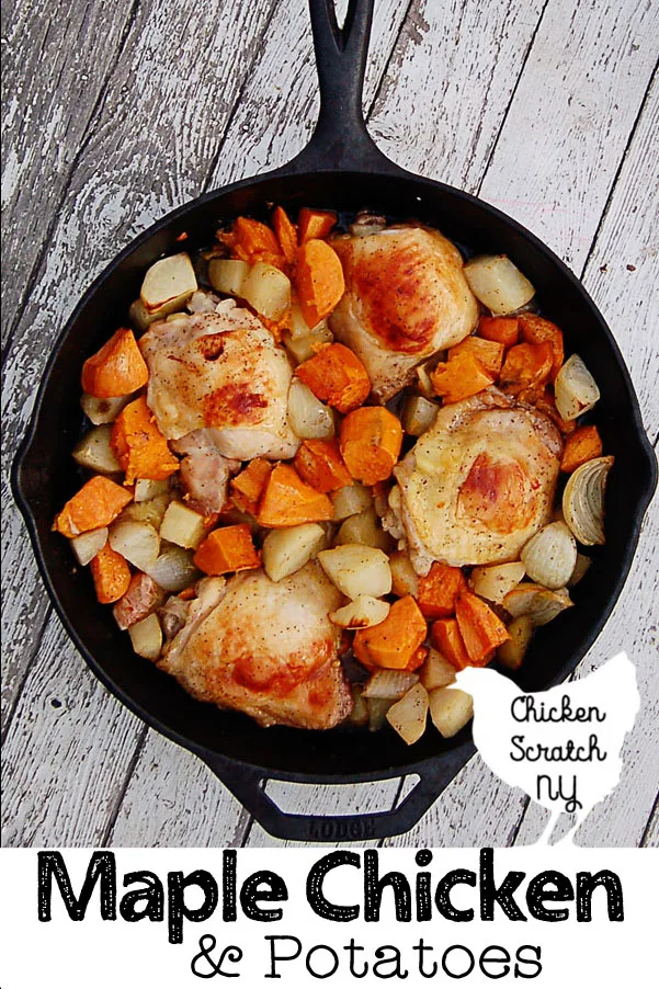 top view of lodge cast iron skillet filled with roasted onions, sweet potatoes, white potatoes and chicken thighs