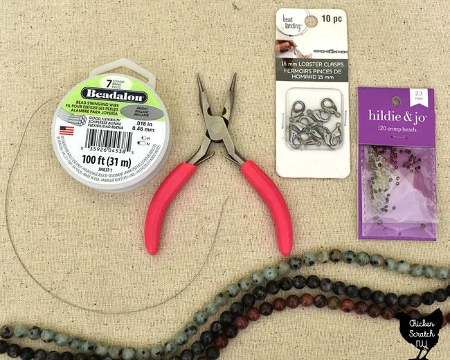 supplies needed for simple diy beaded necklace; beadalon wire, jewelry pliers, crimp beads, lobster claw hooks and natural gemstone beads