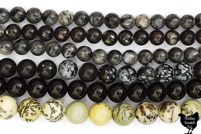 6 strands of black and white natural stone beads including dendritic jasper, rainbow obsidian, snowflake obsidian and black rhyodacite