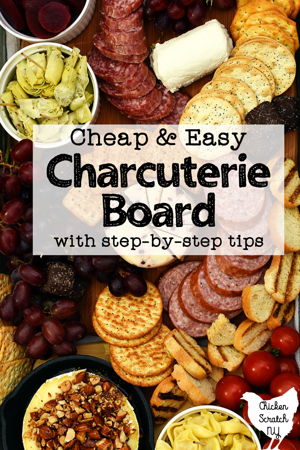 close up view of home made budget charcuterie board including grapes, summer sausage, crackers, maple almond brie, goat cheese, artichoke hearts and more with text overlay "cheap and easy charcuterie board with step-by-step tips"