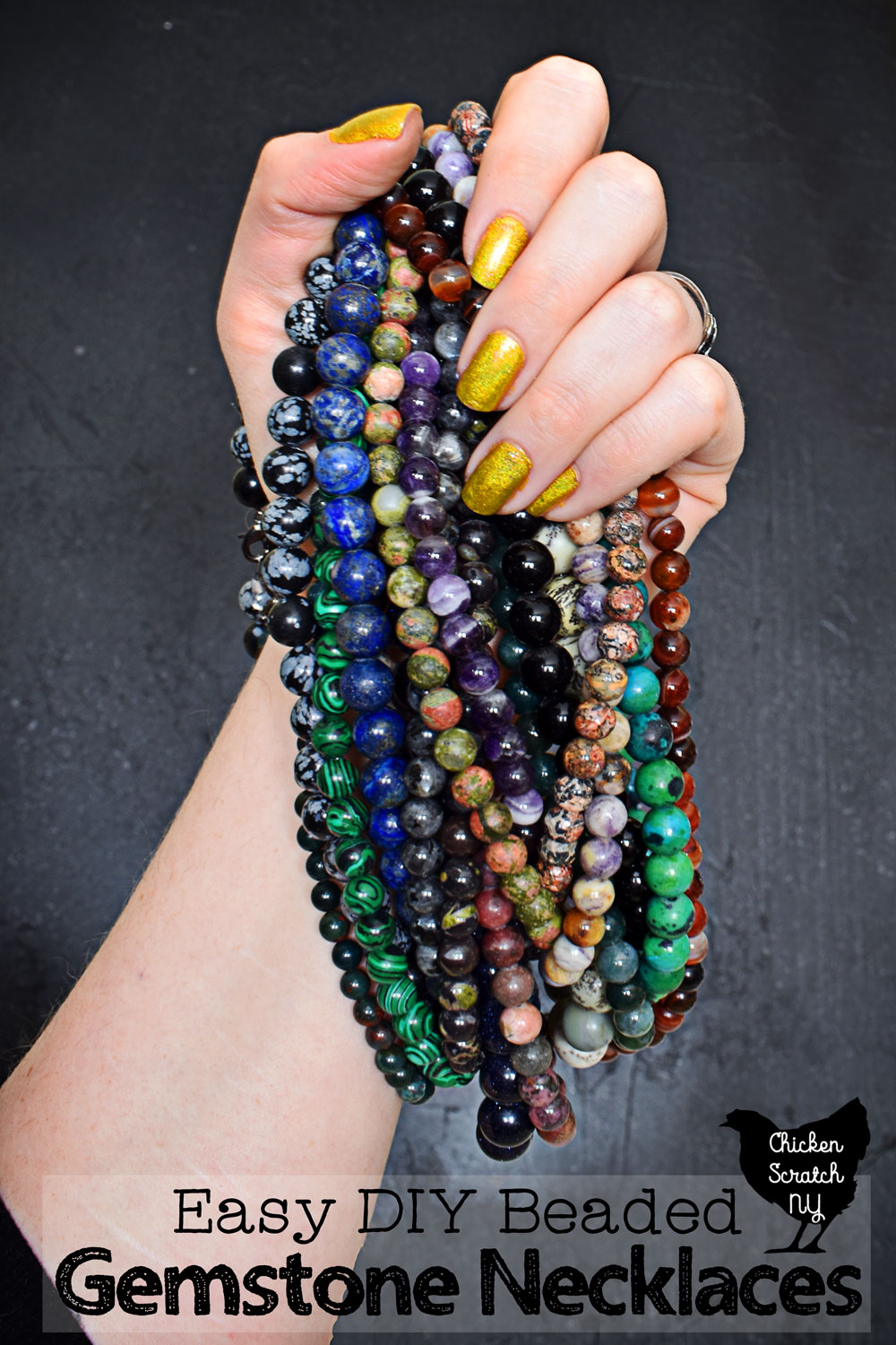 hand holding a pile of homemade DIY beaded gemstone necklaces