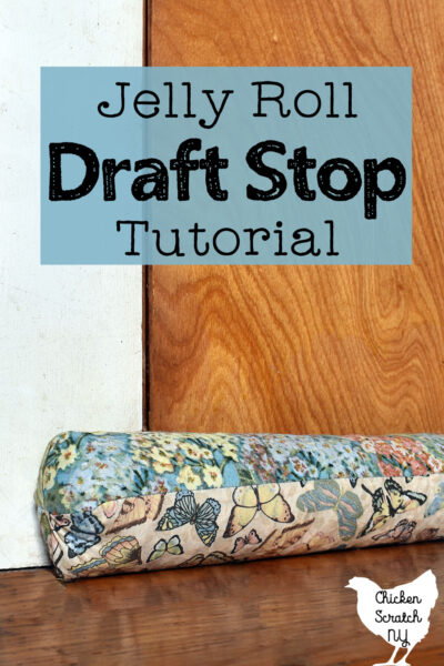 homemade draft stop made with 4 jelly roll strips and filled with corn in front of a wooden door with text overlay "jelly roll draft stop tutorial"