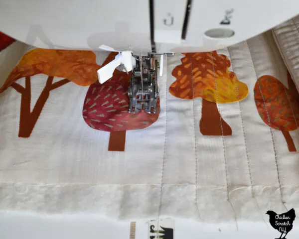 straight line quilting on a narrow table runner with fusible autumn tree shapes 
